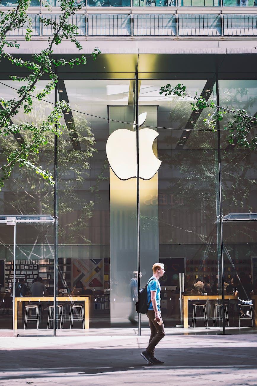 man passing an apple store