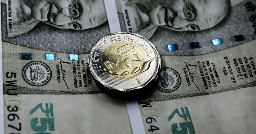 close up shot of a coin on banknote